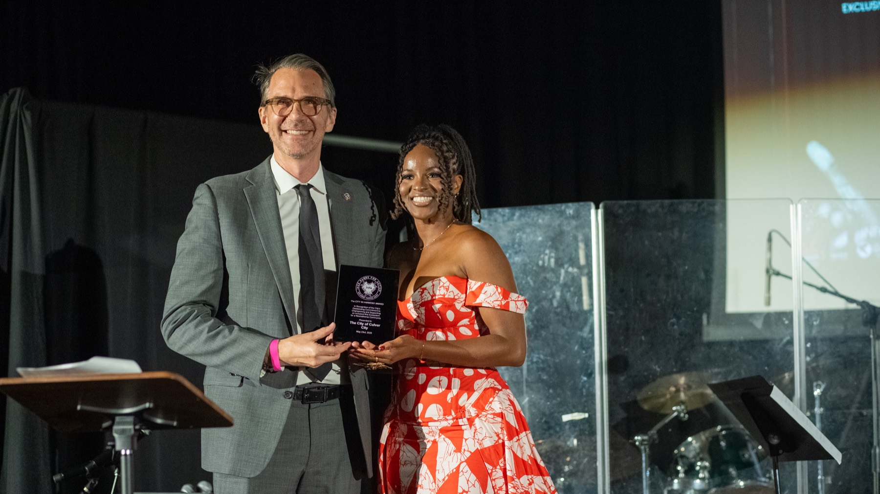 Dr. Ifunanya Nweke presents the City in Harmony Award to Culver City
