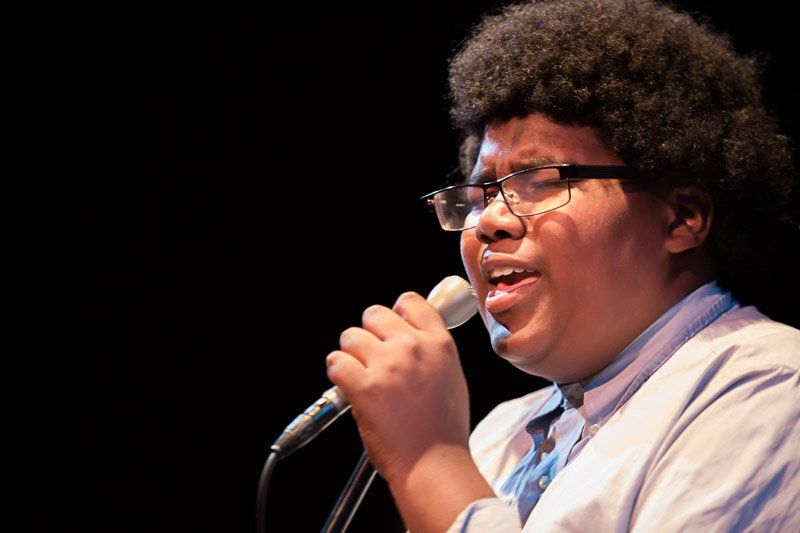 A young vocalist sings at an early Jazz Hands concert