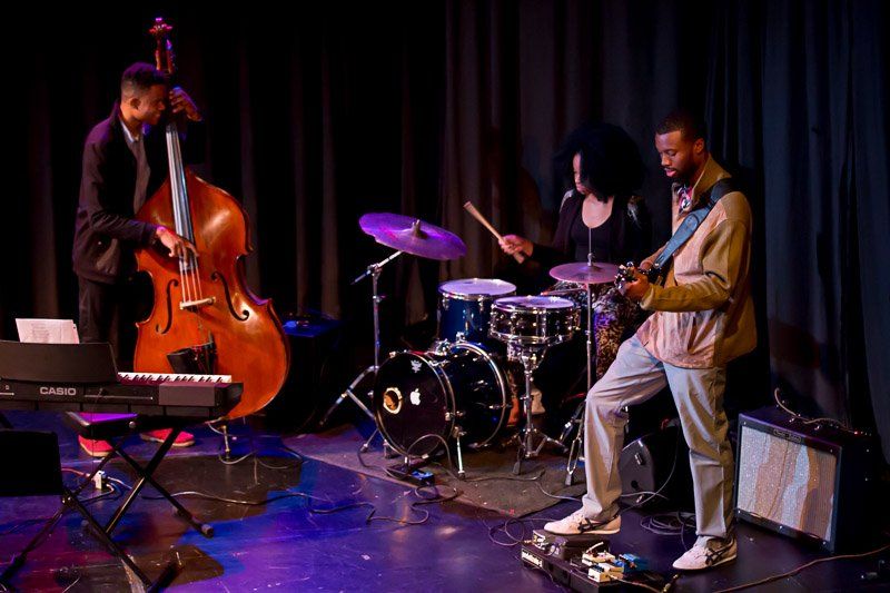 A jazz trio performs on stage at a Jazz Hands concert