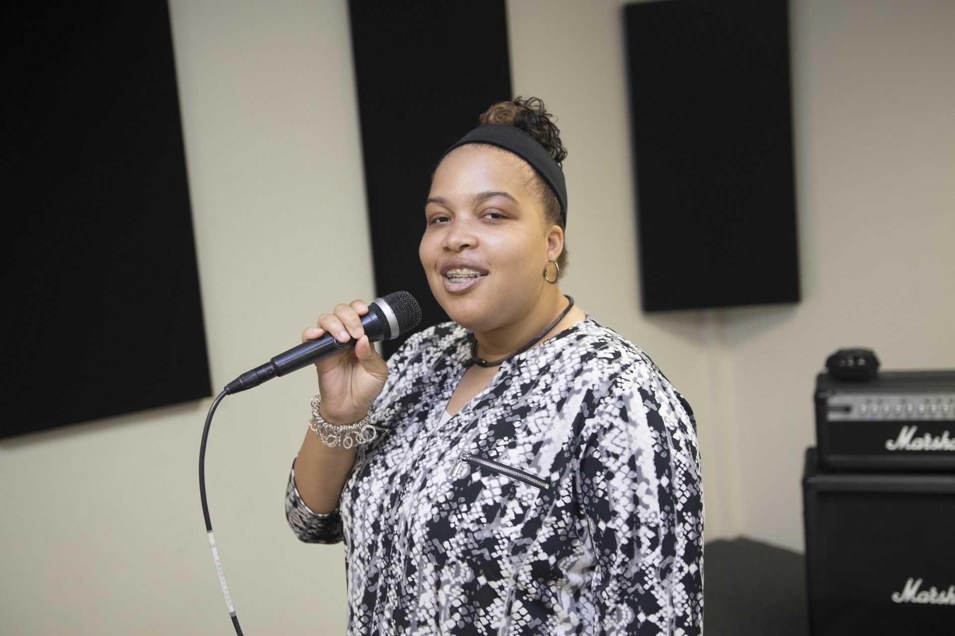 A vocalist records at the microphone